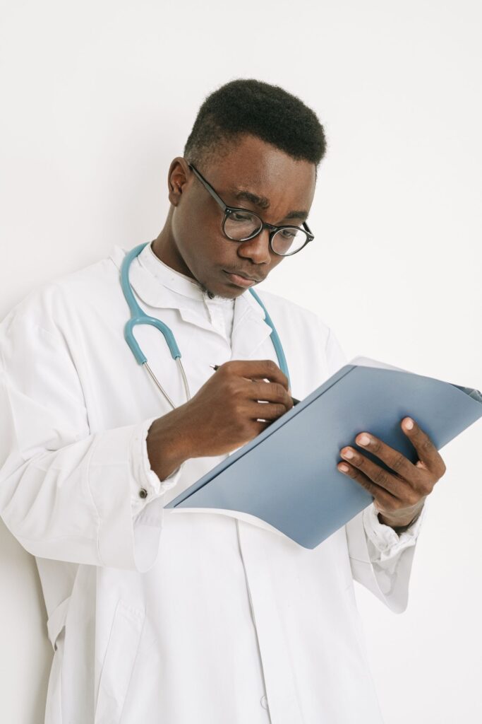 African doctor reviewing a patient's medical documents during rehab admission assessment